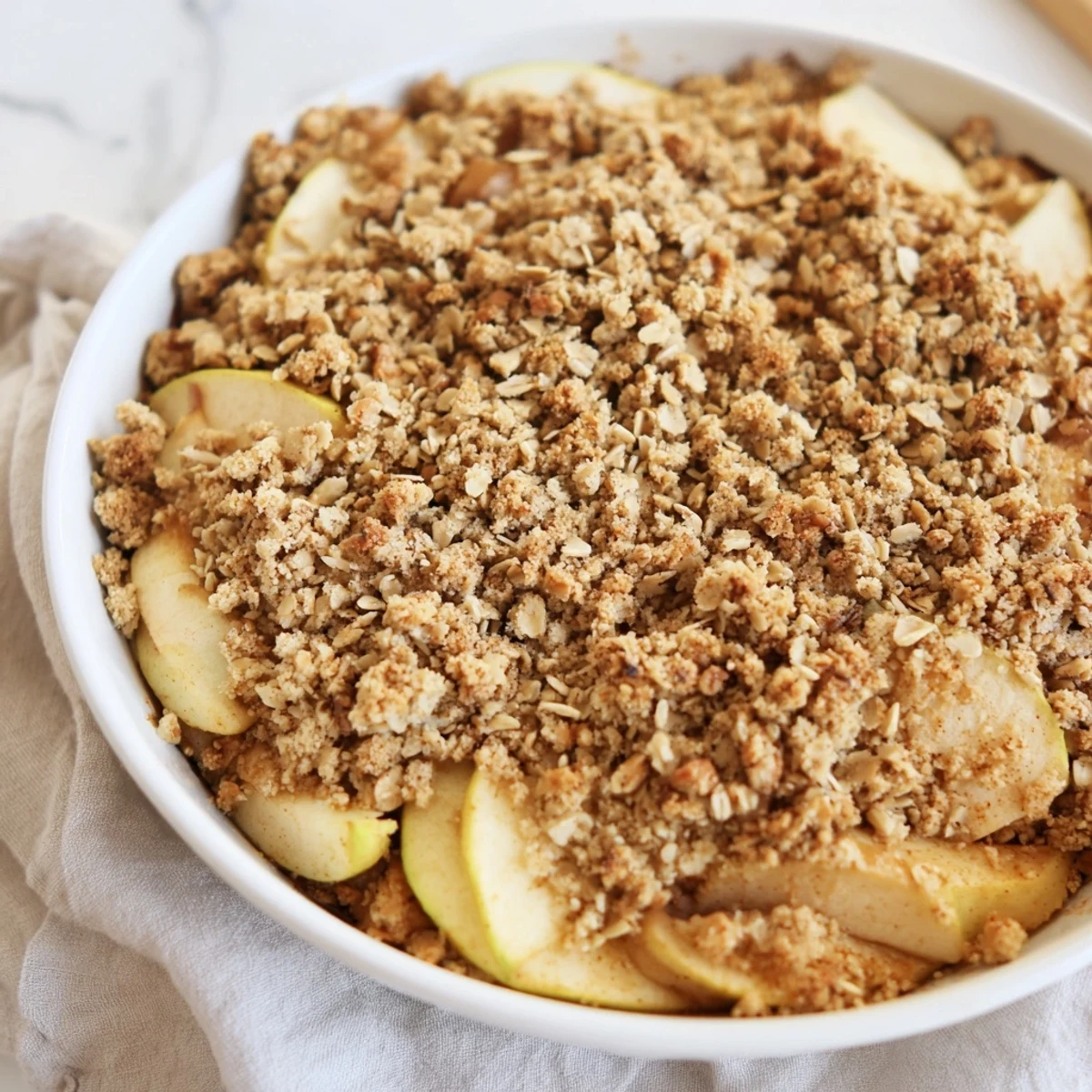 Warm Rustic Apple and Cinnamon Crumble bubbling, a cozy dessert for sharing—golden crumble topping.