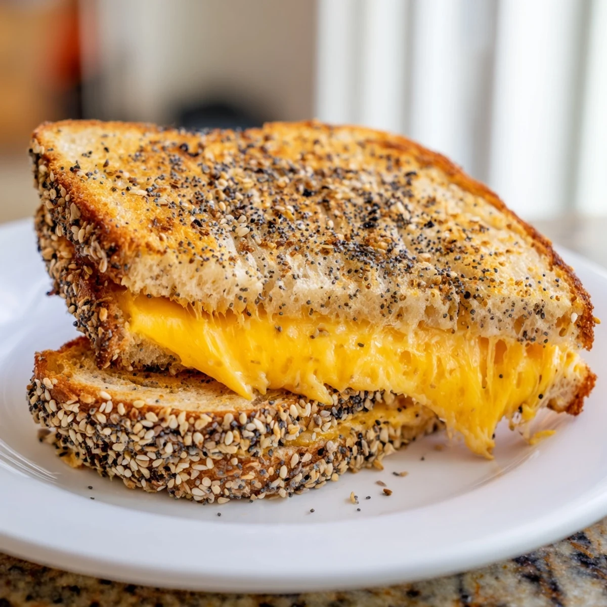 Perfectly grilled Everything Bagel Grilled Cheese ready to serve with a side of tomato soup.