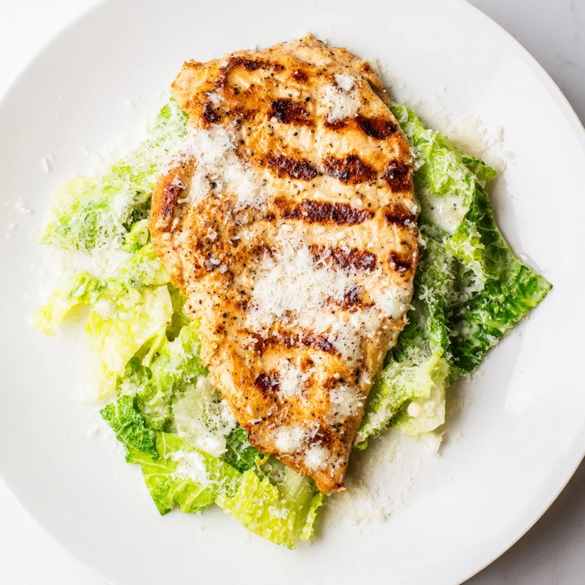 Juicy grilled Caesar chicken sandwich with crisp romaine, creamy dressing, and toasted buns.  