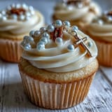 Delicate mini cupcakes decorated with creamy frosting and detailed fondant rosary beads, perfect for religious milestone events.