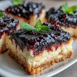 Vibrant, swirled lemon bars with rustic blackberry topping, ready to slice.
