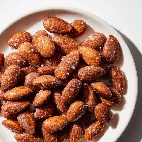 Golden, cinnamon-roasted almonds, a sweet and crunchy snack, ready to enjoy warm or cold.