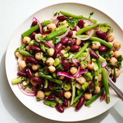 Colorful Three-Bean Salad with chickpeas, green beans, and kidney beans tossed in a tangy vinaigrette.  