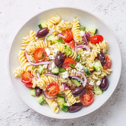 This Mediterranean Olive Oil and Feta Pasta Salad shows a refreshing bowl with Kalamata olives and herbs.