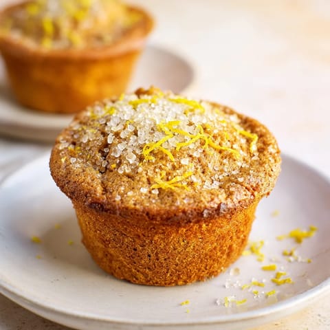 Freshly baked Simple Sweet Lemon Zest Muffins, bursting with citrus zest, perfect alongside coffee.