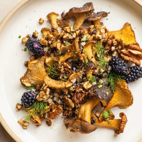 A close-up view of a Northwest Forest Forager salad, showcasing vibrant berries and glistening mushrooms.
