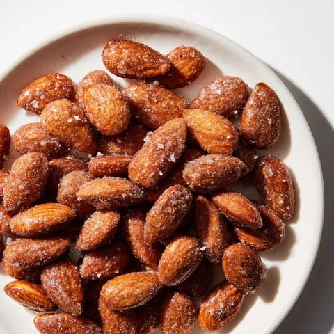 Golden, cinnamon-roasted almonds, a sweet and crunchy snack, ready to enjoy warm or cold.
