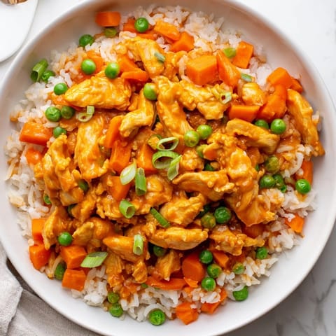 Golden grains of rice mix with tender butter chicken pieces for a comforting fusion meal.