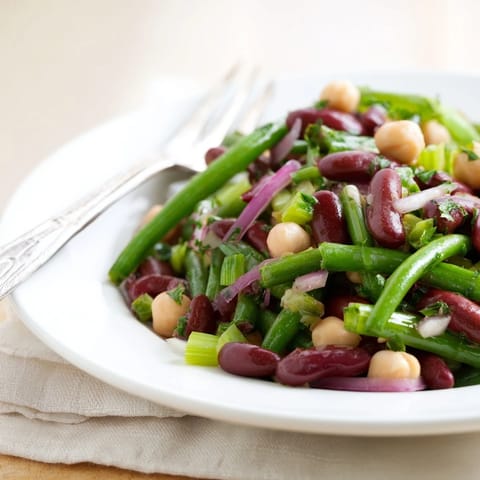 A refreshing Three-Bean Salad with crisp vegetables, perfect for a summer picnic or backyard barbecue.  