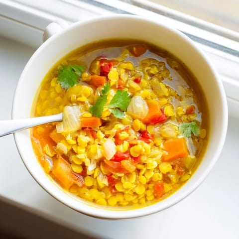 Mung Bean Soup simmering in a pot with carrots and spices, ready to serve.
