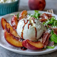 Creamy burrata and juicy peaches combine with salty prosciutto for a vibrant summer salad.